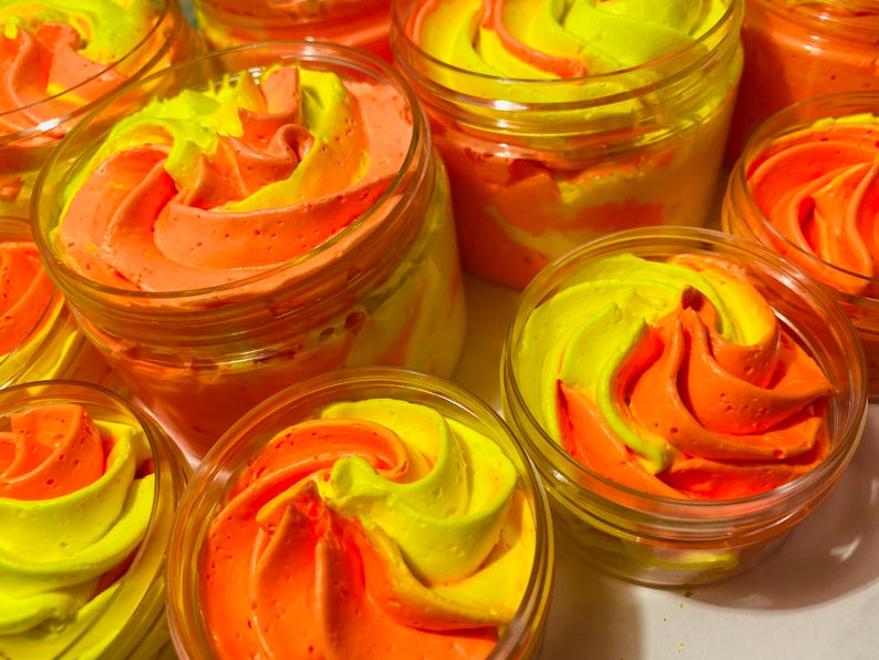 a bunch of oranges in a glass jar 